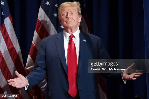 Republican presidential candidate and former President Donald Trump reacts to supporters as he arrives on stage during a Get Out the Vote Rally March...