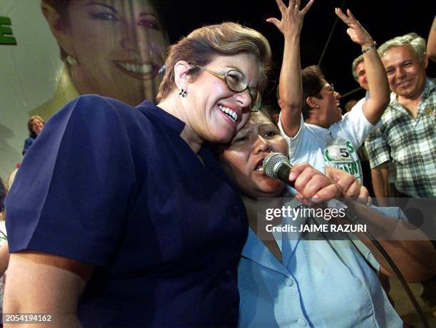 Presidential candidate Lourdes Flores of the National Unity party, hugs a woman from a low-income neighborhood of Lima, Peru, 01 April 2001, during a...