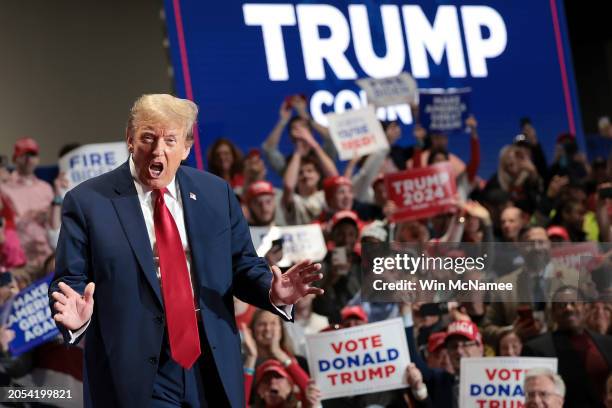 Republican presidential candidate and former President Donald Trump reacts to supporters as he arrives on stage at a Get Out the Vote Rally March 2,...