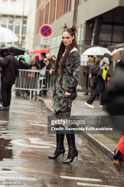 Coco Rocha wears grey, khaki and black dress and black high heels outside Vivienne Westwood during the Womenswear Fall/Winter 2024/2025 as part of...