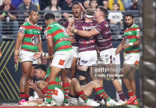 Haumole Olakau'atu of the Sea Eagles celebrates with his team mates after scoring a try during the round one NRL match between Manly Sea Eagles and...