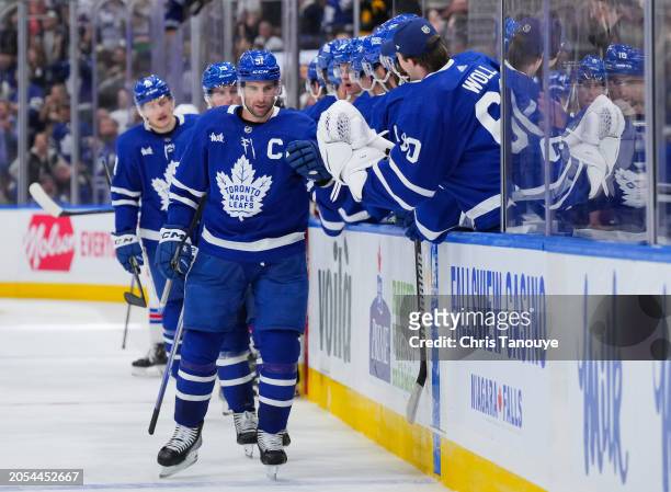 John Tavares of the Toronto Maple Leafs celebrates his third period goal against the New York Rangers with his teammates on the bench at Scotiabank...