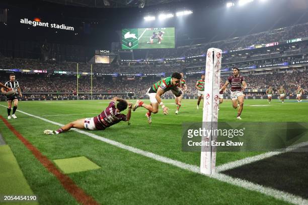 Jacob Gagai of the Rabbitohs breaks the tackle of Jaxson Paulo of the Sea Eagles on his way to score a try during the round one NRL match between...