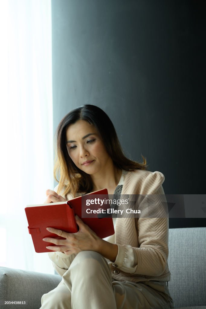 Mature businesswoman at high floor zen like waiting room before her mental health training meeting