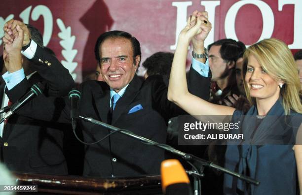 Argentinian Presidential candidate Carlos Menem , with his wife Cecilia Bolocco 27 April 2003 in Buenos Aires after the close of voting. AFP...
