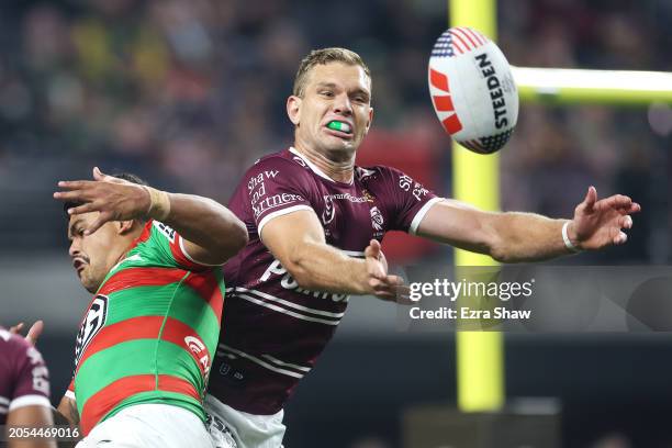 Latrell Mitchell of the Rabbitohs and Tom Trbojevic of the Sea Eagles compete for the ball from a kick during the round one NRL match between Manly...