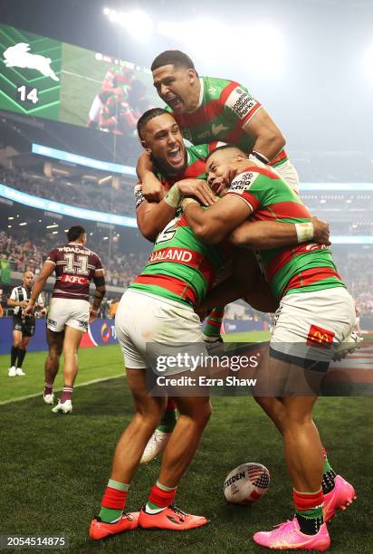 Alex Johnston of the Rabbitohs celebrates with Keaon Koloamatangi, Cody Walker and Richard Kennar of the Rabbitohs after scoring a try during the...