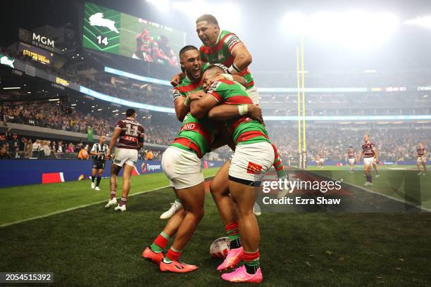 Alex Johnston of the Rabbitohs celebrates with Keaon Koloamatangi, Cody Walker and Richard Kennar of the Rabbitohs after scoring a try during the...