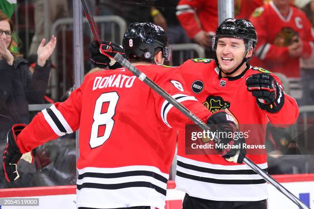 Ryan Donato of the Chicago Blackhawks celebrates with Philipp Kurashev after scoring a goal against the Columbus Blue Jackets during the third period...