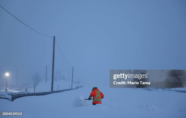 Union Pacific worker shovels snow near the railroad tracks during a powerful multiple day winter storm in the Sierra Nevada mountains on March 02,...