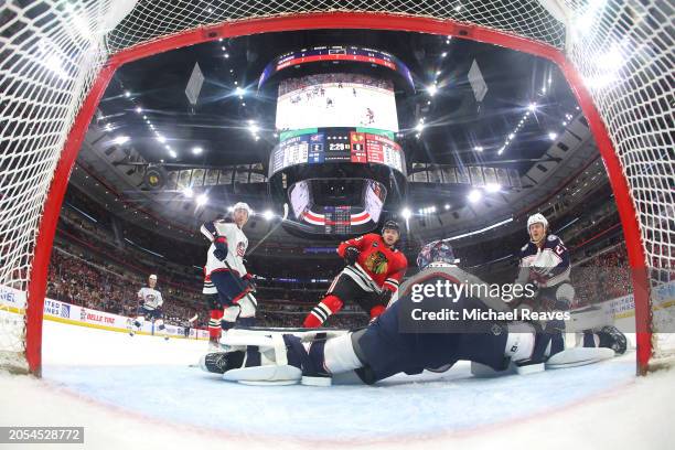 Philipp Kurashev of the Chicago Blackhawks scores a goal past Elvis Merzlikins of the Columbus Blue Jackets during the first period at the United...