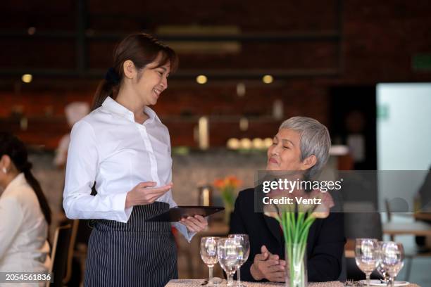attractive waitress smiling - ober stockfoto's en -beelden
