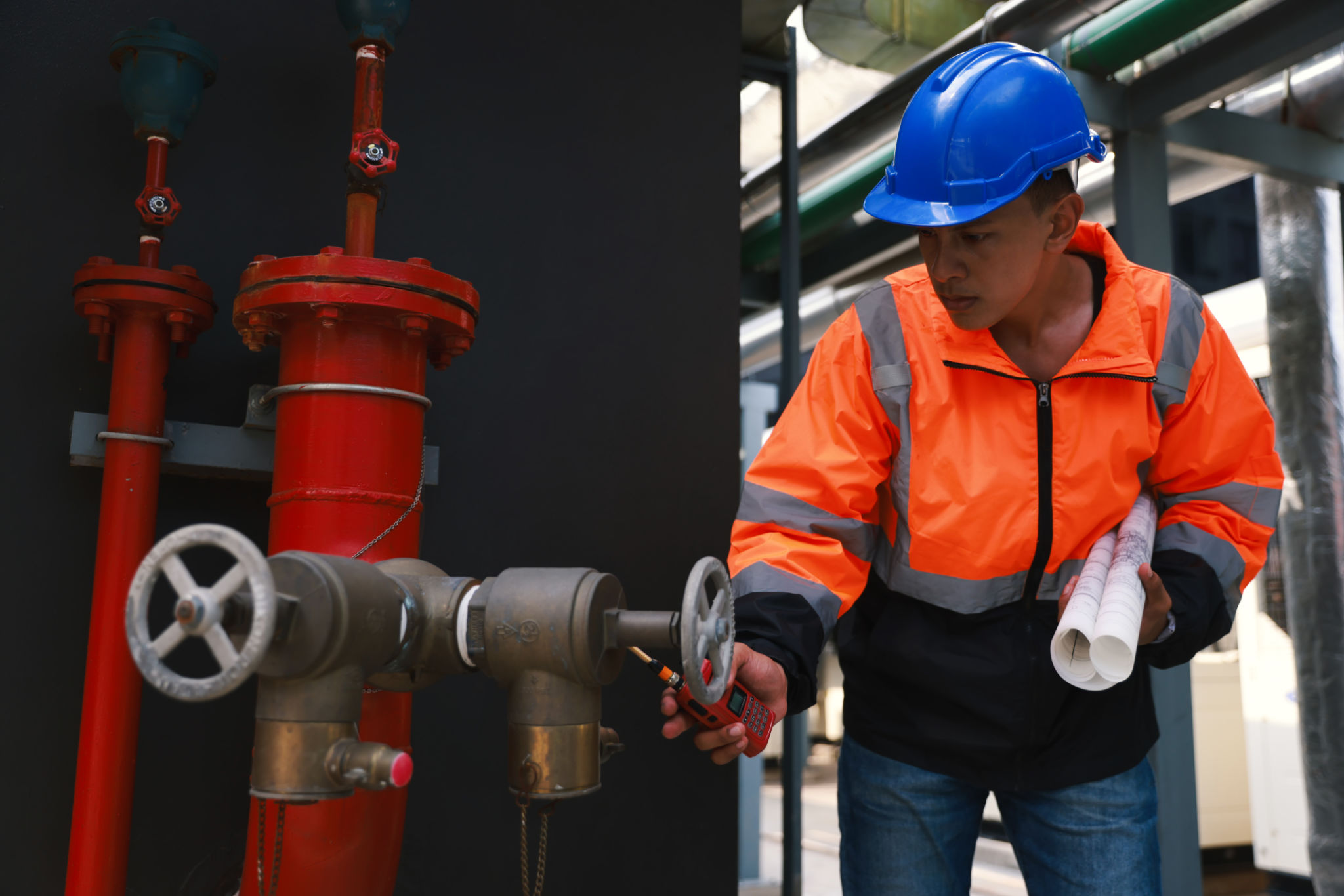 Maintenance engineer working with digital tablet and drawing check Fire hydrant system. Engineering and factory concept Maintenance engineer working with digital tablet and drawing check Fire hydrant system. Engineering and factory concept