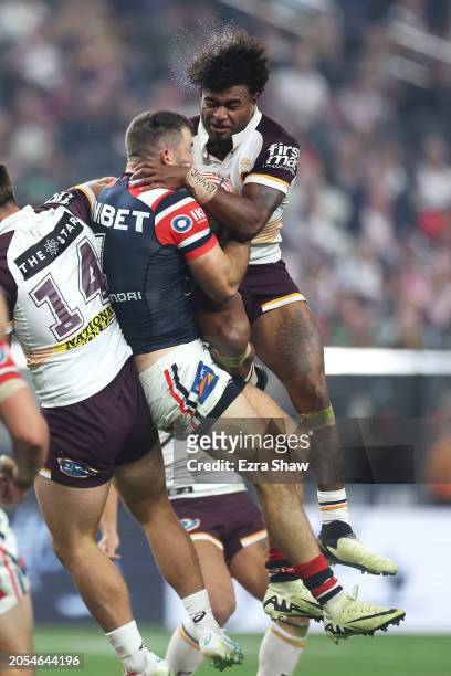 James Tedesco of the Roosters and Ezra Mam of the Broncos compete for the ball from a kickduring the round one NRL match between Sydney Roosters and...