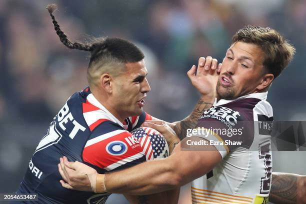 Terrell May of the Roosters is tackled by Tyson Smoothy of the Broncos during the round one NRL match between Sydney Roosters and Brisbane Broncos at...