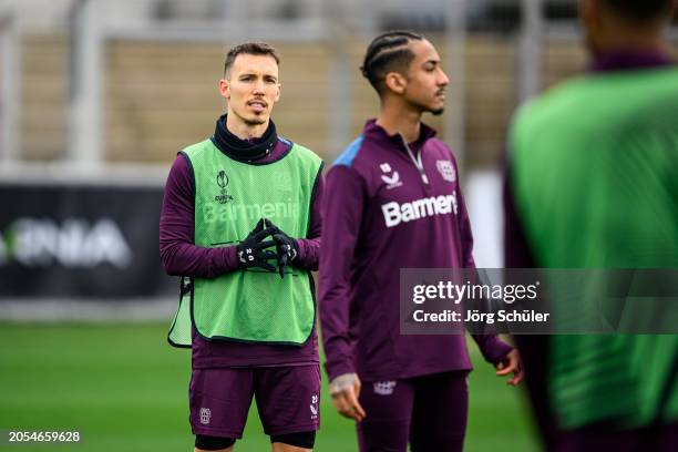 Alejandro Grimaldo and Arthur look on during the UEFA Europa League 2023/24 round of 16 first leg training and press conference at BayArena on March...