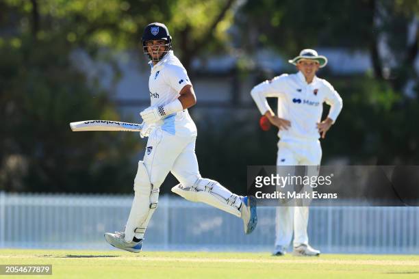 Ollie Davies of New South Wales runs between wickets to reach a century during the Sheffield Shield match between New South Wales and South Australia...