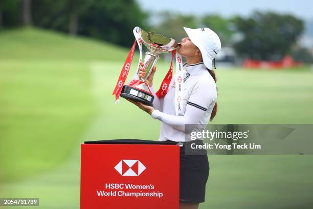 Hannah Green of Australia kisses the trophy in celebration of victory on the 18th green on Day Four of the HSBC Women's World Championship at Sentosa...