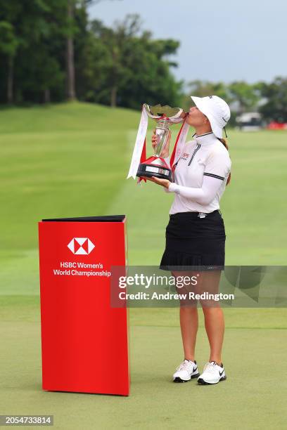 Hannah Green of Australia kisses the trophy in celebration of victory on the 18th green on Day Four of the HSBC Women's World Championship at Sentosa...