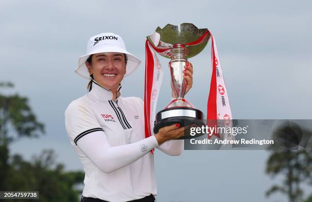 Hannah Green of Australia poses with the trophy in celebration of victory on the 18th green on Day Four of the HSBC Women's World Championship at...