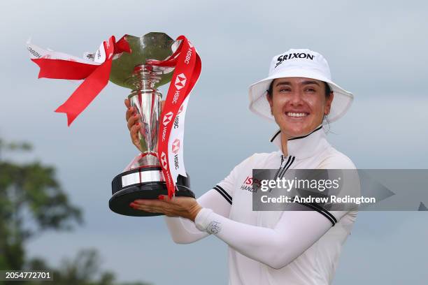 Hannah Green of Australia poses with the trophy in celebration of victory on the 18th green on Day Four of the HSBC Women's World Championship at...