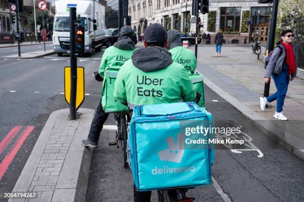 Uber Eats takeaway delivery cycle couriers on 5th March 2024 in London, United Kingdom. Uber Eats is an online food ordering and delivery platform...