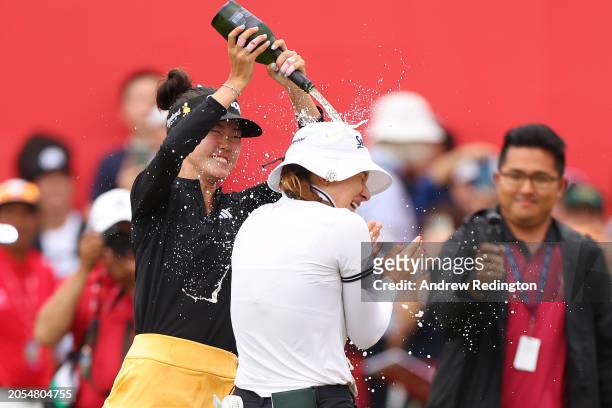 Grace Kim of Australia pours drinks over Hannah Green of Australia on the 18th green, in celebration of her victory on Day Four of the HSBC Women's...