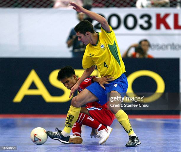 Dovenir Dominigues Neto of Brazil is held off by Anucha Manjarern of Thailand during the match between Thailand and Brazil in the 2003 World 5's...