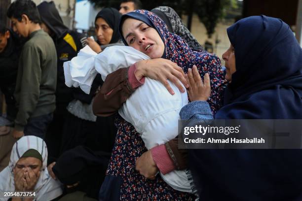 People mourn as they receive the dead bodies of victims of an Israeli strike on March 3, 2024 in Rafah, Gaza. As of Thursday February 29th, more than...