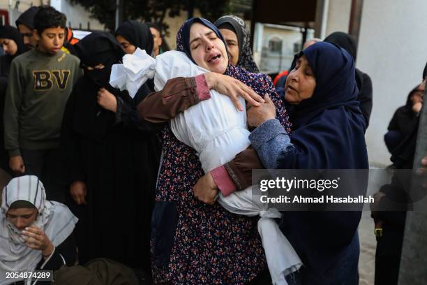 People mourn as they receive the dead bodies of victims of an Israeli strike on March 3, 2024 in Rafah, Gaza. As of Thursday February 29th, more than...