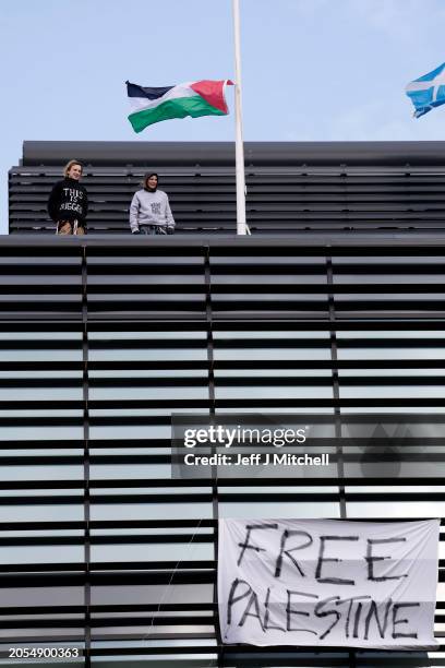 Protesters on the roof of a government building fly the Palestinian flag on March 06, 2024 in Edinburgh, Scotland. The group "This Is Rigged" doused...