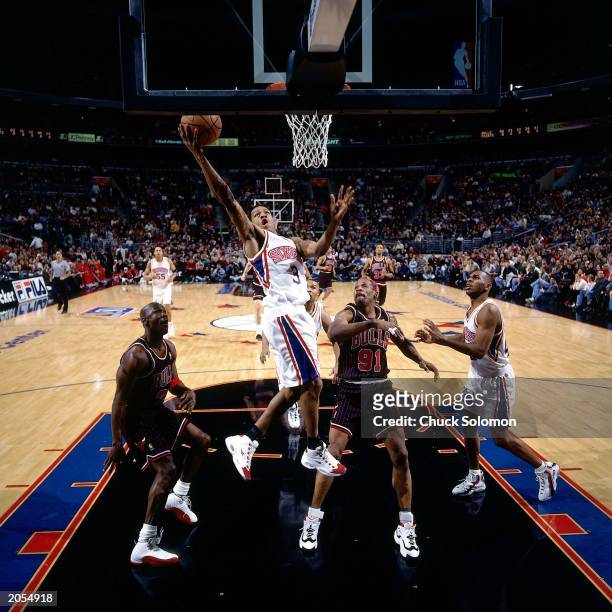 Allen Iverson of the Philadelphia 76ers shoots against Michael Jordan and Dennis Rodman of the Chicago Bulls during the NBA game at the Spectrum on...