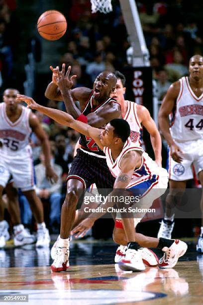 Allen Iverson of the Philadelphia 76ers steals the ball from Michael Jordan of the Chicago Bulls during the NBA game at the Spectrum on December 21,...