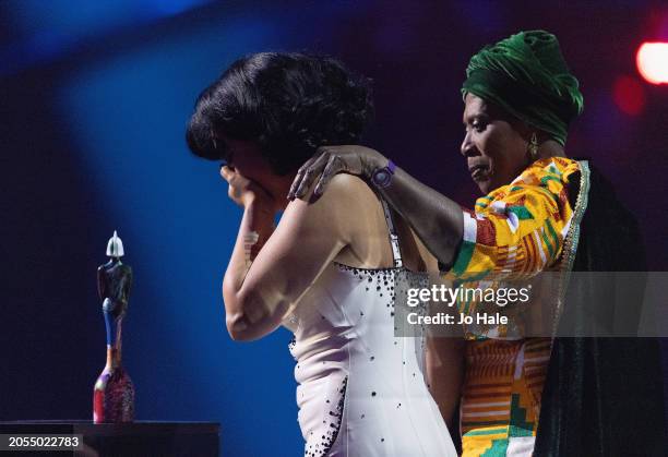 Raye shows emotion with her Grandmother Agatha Dawson after winning her fourth brit award for best album during the BRIT Awards 2024 at The O2 Arena...