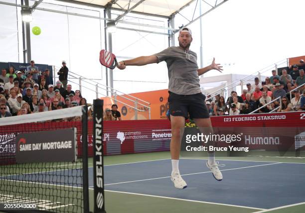 Jack Sock leaps to hit a backhand volley shot for a winner against Federico Staksrud in the 2024 PPA Carvana Mesa Arizona Cup semi-finals match of...