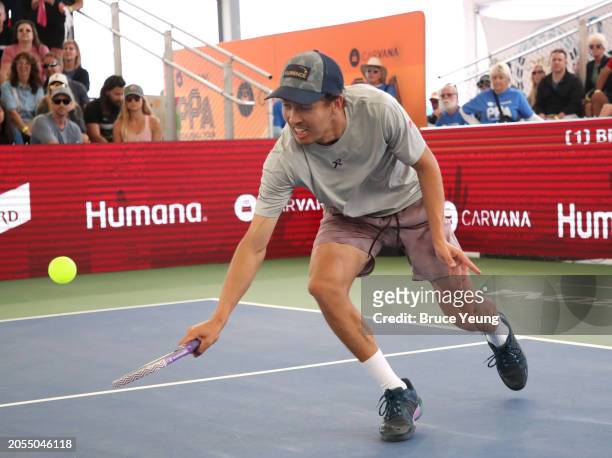 Connor Garnett approaches the net to hit a backhand slice drop shot against Ben Johns in the 2024 PPA Carvana Mesa Arizona Cup semi-finals match of...