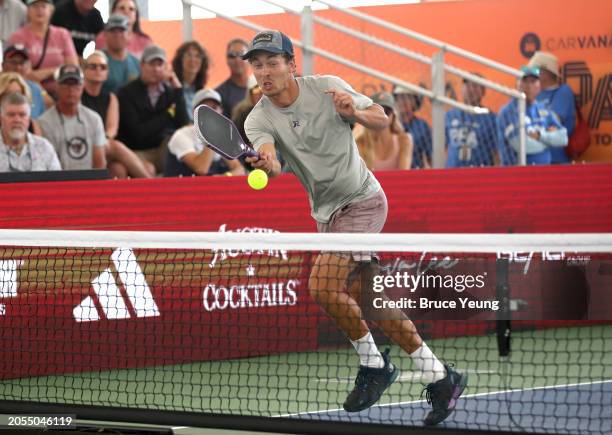 Connor Garnett leaps over the kitchen to hit a flying erne shot cross court against Ben Johns in the 2024 PPA Carvana Mesa Arizona Cup semi-finals...