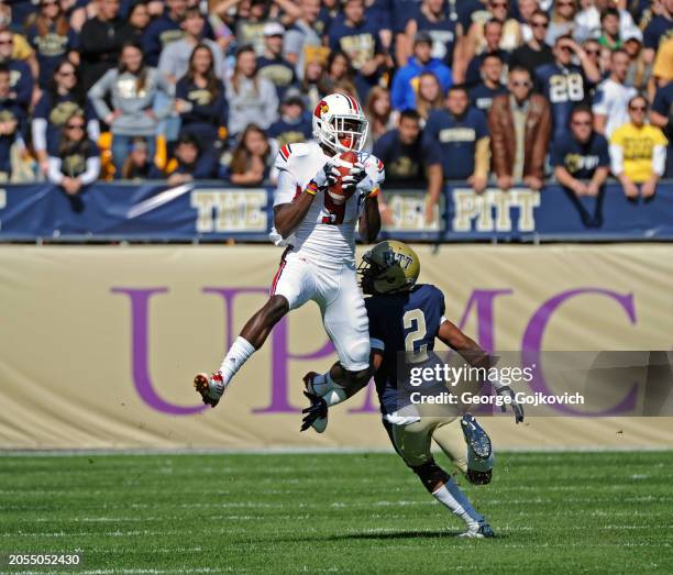 Wide receiver DeVante Parker of the University of Louisville Cardinals catches a pass against cornerback K'Waun Williams of the University of...