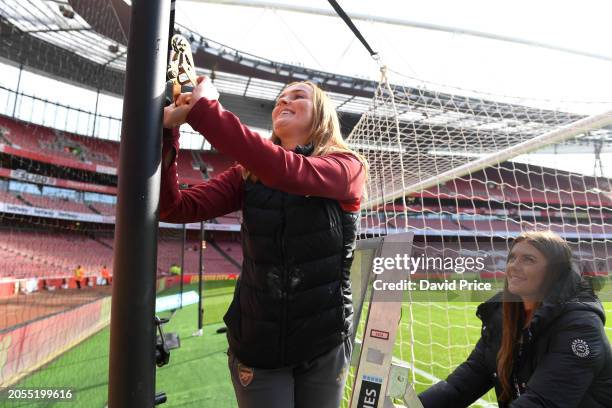 Members of the Arsenal Ground Staff Team prepare the net supports for the Goals prior to the Barclays Women's Super League match between Arsenal FC...