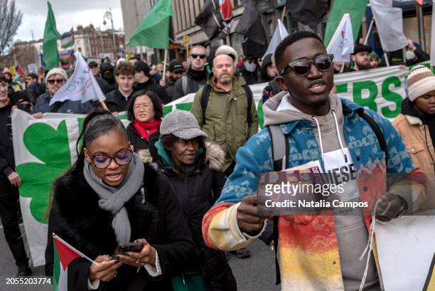 Group of protesters march holding banners, flags, and placards during the demonstration on March 2, 2024 in Dublin, Ireland. Le Chéile, an anti-far...