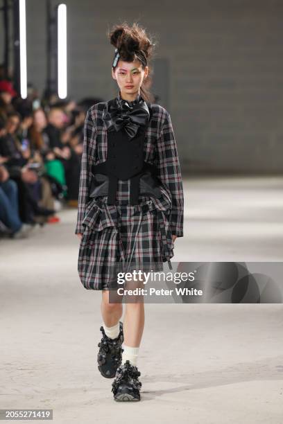 Model walks the runway during the Noir Kei Ninomiya Womenswear Fall/Winter 2024-2025 show as part of Paris Fashion Week on March 02, 2024 in Paris,...