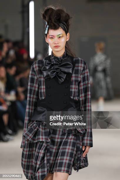 Model walks the runway during the Noir Kei Ninomiya Womenswear Fall/Winter 2024-2025 show as part of Paris Fashion Week on March 02, 2024 in Paris,...