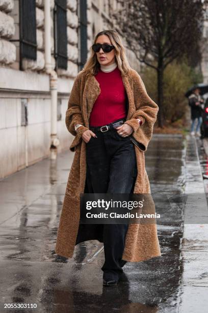 Angela Fink, wears red top, black jeans, beige fur coat, black sunglasses, outside Hermes, during the Womenswear Fall/Winter 2024/2025 as part of...