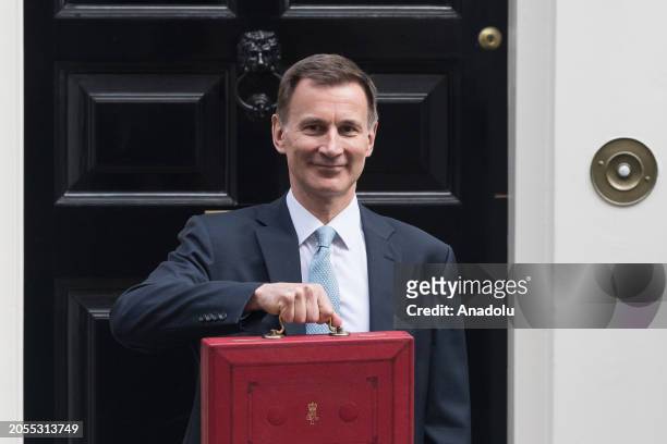 Britain's Chancellor of the Exchequer Jeremy Hunt holds a red dispatch box outside 11 Downing Street ahead of the announcement of the Spring Budget...