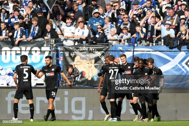 Lukas Kunze of VfL Osnabrueck celebrates scoring his team's first goal with teammates during the Second Bundesliga match between Hamburger SV and VfL...