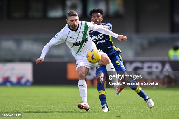 Domenico Berardi of US Sassuolo is challenged by Juan Cabal of Hellas Verona FC during the Serie A TIM match between Hellas Verona FC and US Sassuolo...