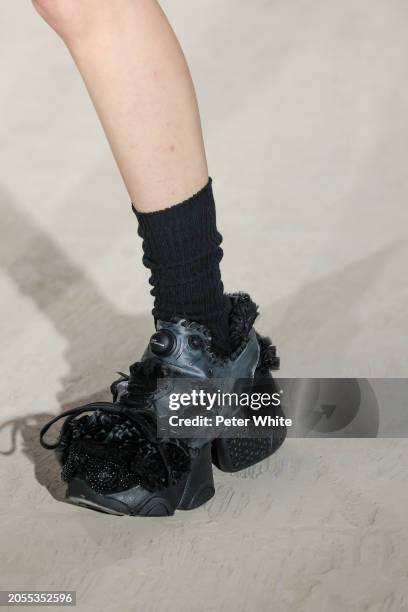 Model, shoe detail, walks the runway during the Noir Kei Ninomiya Womenswear Fall/Winter 2024-2025 show as part of Paris Fashion Week on March 02,...