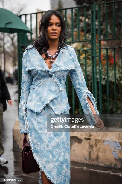 Khaoula Madi, wears light blue decorated jacket with matching skirt, burgundy Vivienne Westwood bag, outside Vivienne Westwood, during the Womenswear...