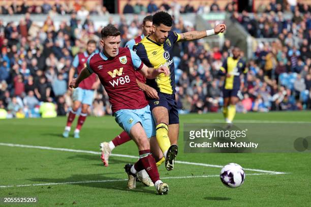 Dara O'Shea of Burnley clears the ball whilst under pressure from Dominic Solanke of AFC Bournemouth during the Premier League match between Burnley...