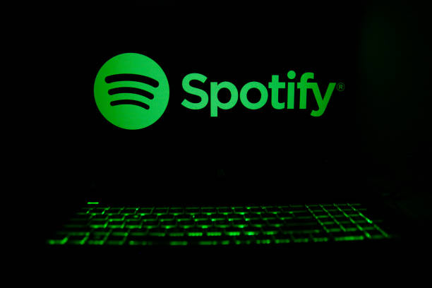 The Spotify logo is being displayed on a laptop screen with a glowing keyboard in Krakow, Poland, on March 3, 2024.